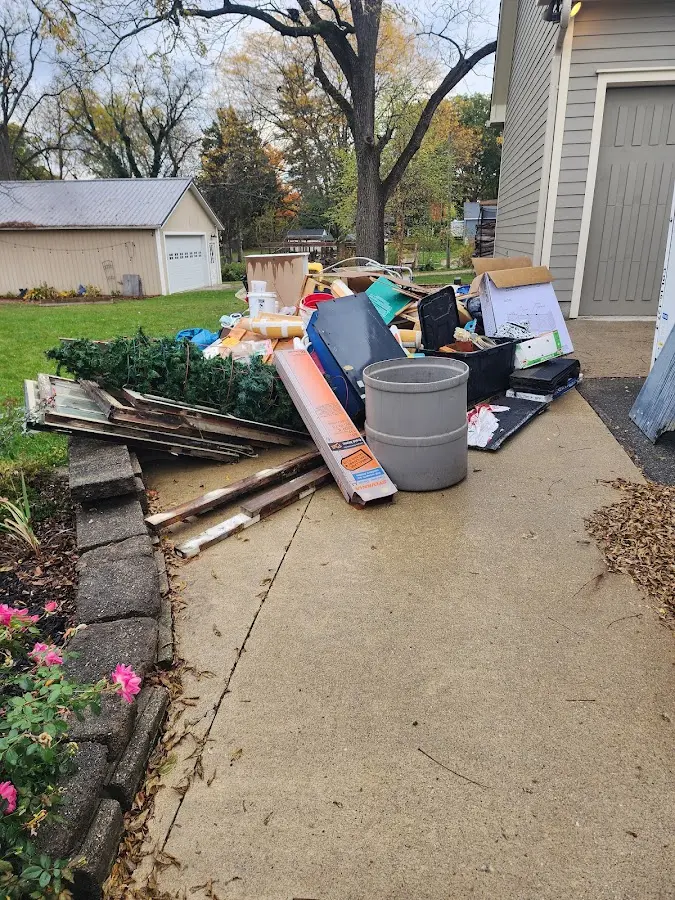 Dumpster being loaded with debris for 12 Yard Dumpster Rental in Schroeppel